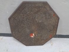 An early 20th century carved eastern octagonal table top