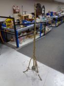 An Arts & Crafts brass floor lamp