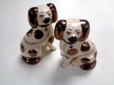 A pair of copper lustre Staffordshire spaniels.