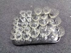 A tray containing antique etched glass drinking glasses