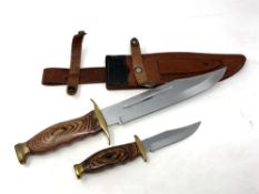 A Bowie knife with brass hilt with matching smaller knife in leather sheath