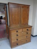 A 19th century oak double door cabinet on five drawer chest
