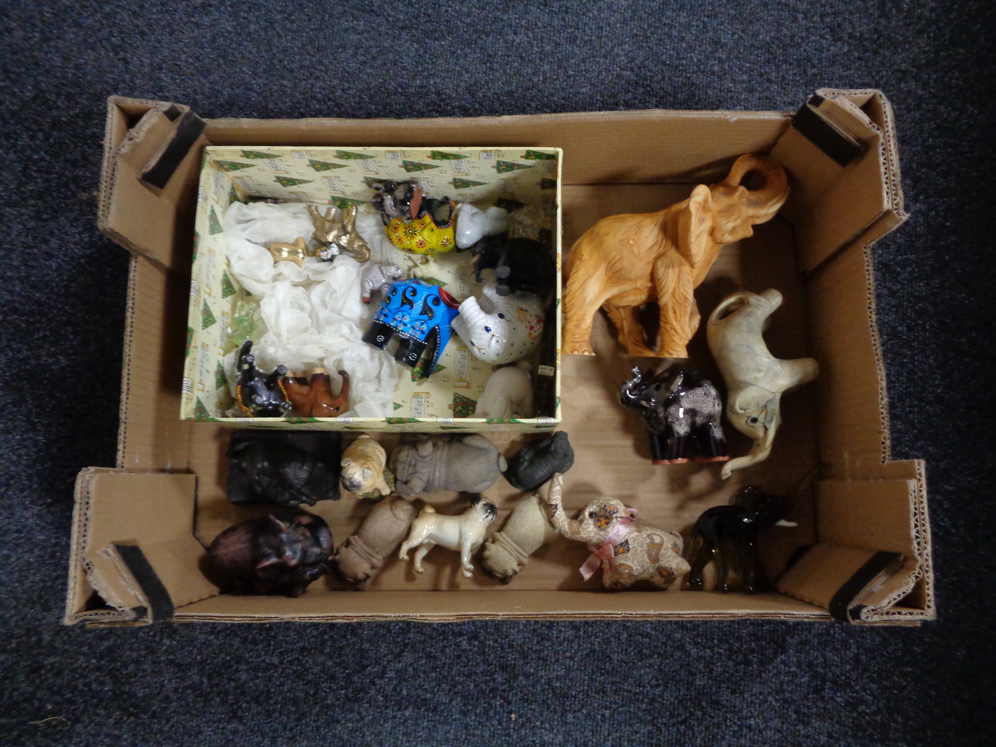 A box of a quantity of elephant and pug ornaments to include glass and ceramic examples,