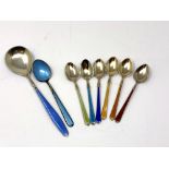 A set of six silver-gilt and enamelled teaspoons together with two other similar spoons