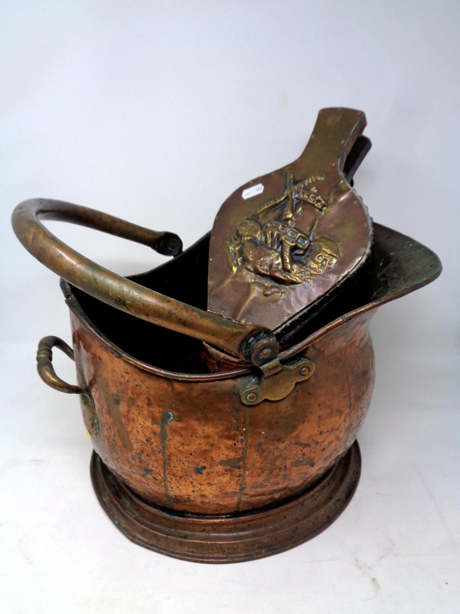 A 19th century copper coal bucket together with a set of brass embossed bellows