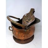 A 19th century copper coal bucket together with a set of brass embossed bellows