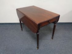 A 19th century mahogany flap sided table fitted a drawer