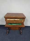 A Victorian mahogany and walnut work table with marquetry inlay fitted a drawer and basket beneath,