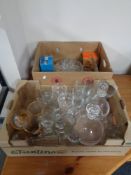 Two boxes containing a quantity of assorted glassware to include drinking glasses, decanters, vases,