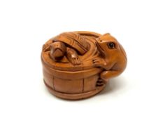 A carved Chinese hardwood netsuke - Tortoise and frog in barrel