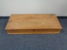 An antique pine clerk's writing slope.
