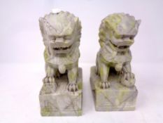 A pair of Chinese polished stone foo dogs, height 19.