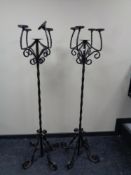 A pair of wrought iron floor standing five way candelabra