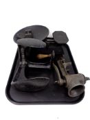 A tray containing antique and later metalware to include cobbler's last, universal mincer,