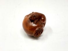 A carved Chinese hardwood netsuke - Rats on a pot