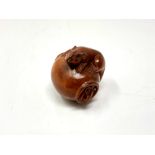 A carved Chinese hardwood netsuke - Rats on a pot