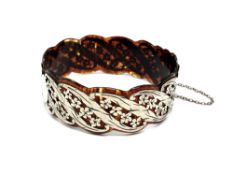 A fine quality antique silver and tortoiseshell bangle.