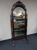 A Victorian style cheval mirror in mahogany finish
