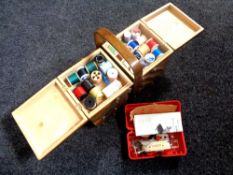 A concertina sewing box containing sewing accessories together with a cased Singer button hole