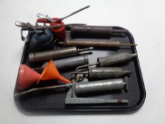 A tray of vintage oil cans and grease guns