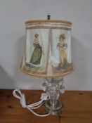 A cut glass table lamp with glass drops and shade