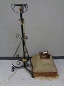 An antique wrought iron rise and fall oil lamp stand (converted to electric) with a vintage