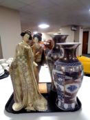 Two Japanese style blue and gilt vases and two figures of Geisha