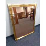 A brass framed copper tinted mirror