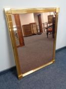 A brass framed copper tinted mirror