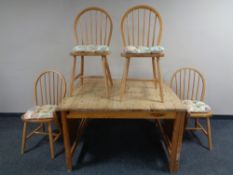 A pine flap sided kitchen table together with four rail back chairs