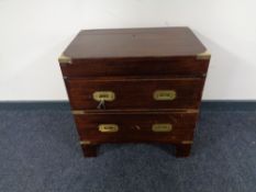 A ship's style chest with brass mounts and handles in the form of a two drawer chest