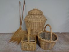 A wicker laundry basket together with two further wicker hand baskets and two fly swishes