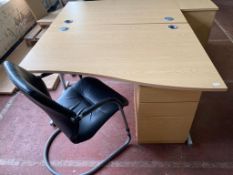 A light oak effect desk, width 140 cm, together with three chest and black leather chair.