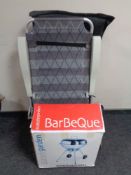 A boxed Scandy garden barbecue together with a garden lounger in carry bag