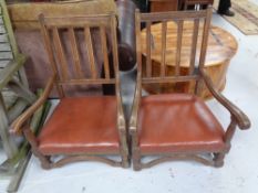 A pair of Edwardian oak rail back armchairs