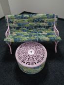 An up-cycled cast iron garden bench upholstered in fabric and matching occasional table