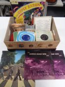 A box of vinyl LP's and 7" singles to include The Beatles, Tom Jones, Simon & Garfunkel,