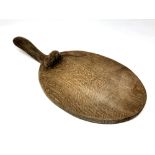 A Robert 'Mouseman' Thompson of Kilburn oak cheese board, with carved mouse signature,