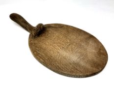 A Robert 'Mouseman' Thompson of Kilburn oak cheese board, with carved mouse signature,