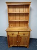 A pine kitchen dresser with cupboard and drawers beneath CONDITION REPORT: 95 cm W x