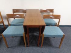 A mid 20th century teak G Plan drop leaf table and four chairs