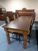 A heavily carved oak Elizabethan style refectory dining table with brown faux leather inset