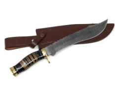 A bowie knife with pattern-welded blade, in leather sheath.