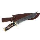 A bowie knife with pattern-welded blade, in leather sheath.