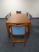 A mid 20th century teak extending table and six chairs upholstered in blue dralon