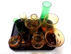 A tray containing 20th century green and amber coloured glassware