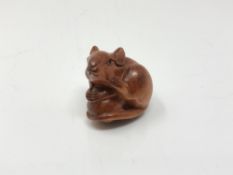 A carved Chinese hardwood netsuke - Rat on fruit