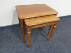 A nest of two teak tables