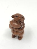 A carved Chinese hardwood netsuke - Pig