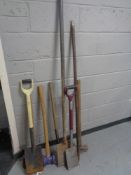 A bundle of assorted garden tools and sledgehammers